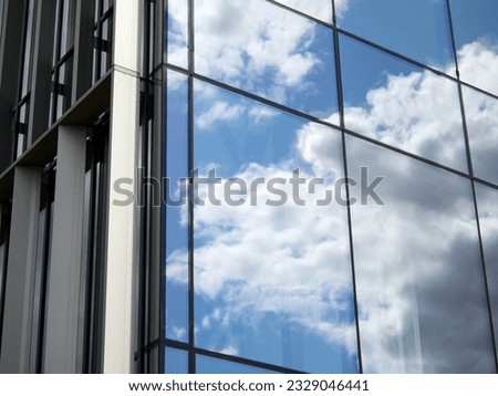 Mirror glazing of the business center. Reflection of the sky and clouds in the windows of the building