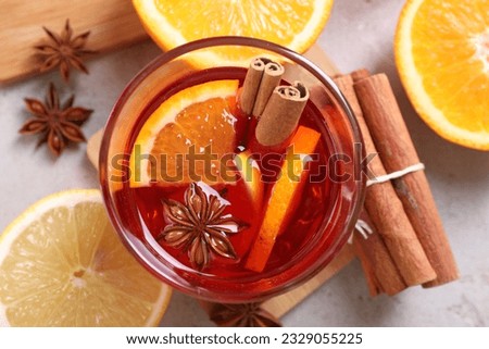 Aromatic punch drink and ingredients on light grey table, flat lay Royalty-Free Stock Photo #2329055225