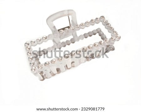 Picture of a light pink hair clip on a white background