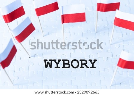 Polish white and red flags and the inscription WYBORY, meaning elections in English, Concept, Elections in Poland, encouragement to vote Royalty-Free Stock Photo #2329092665
