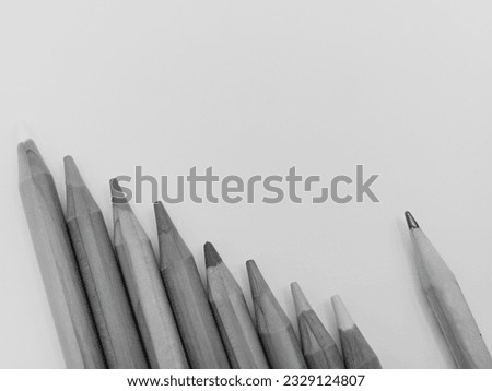 Black and white picture of a pencil lying on the floor.