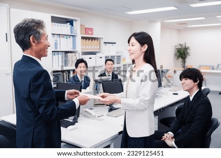 Female employees receiving congratulations at work Royalty-Free Stock Photo #2329125451