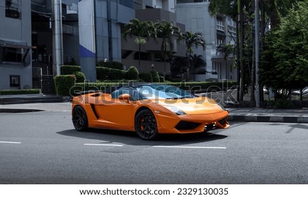 Luxury sports car in a city with impressive architecture Royalty-Free Stock Photo #2329130035
