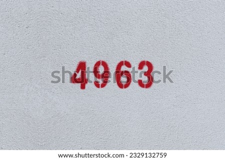 Red Number 4963 on the white wall. Spray paint.
