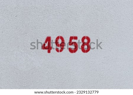 Red Number 4958 on the white wall. Spray paint.
