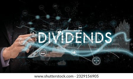 Businessman pressing button on touch screen interface and select Dividends. Business concept. Internet concept.