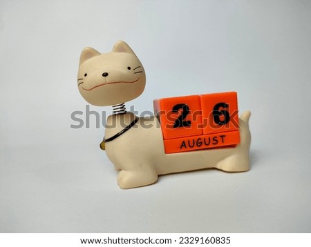 a unique august teddy cat calendar with blocks with the date and month written on it, on a white background