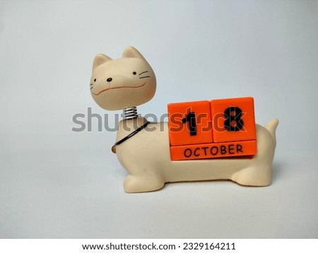 a unique october teddy cat calendar with blocks with the date and month written on it, on a white background