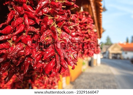 Famous Hungarian dried red pepper or paprika in souvenir shop on a cozy street of the Tihany village in summer time, outdoor travel background, Veszprem region, Hungary Royalty-Free Stock Photo #2329166047