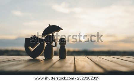 Shield protect icon and family model with umbrella, Security protection and health insurance. The concept of family home, protection, health care day, car insurance. Royalty-Free Stock Photo #2329182319