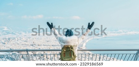 Woman tourist Visiting in Hakodate, Traveler in Sweater sightseeing view from Hakodate mountain with Snow in winter. landmark and popular for attractions in Hokkaido, Japan.Travel and Vacation concept Royalty-Free Stock Photo #2329186569