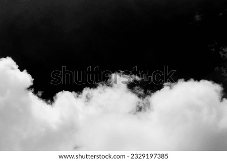 Clouds over black background .	