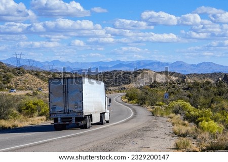 A semitruck rumbles down U.S. Highway 93 in Arizona. Royalty-Free Stock Photo #2329200147