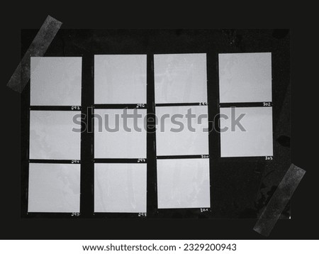 handcopy medium format paper sheet with empty frames fixed by transparent sticker tape on black background, cool photo placeholder.