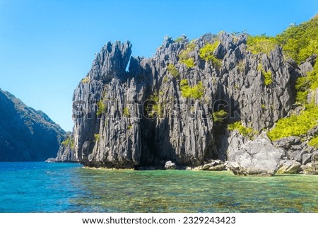 Untouched nature in El Nido, Palawan, Philippines. Black limestone rocks, blue sky, copy space Royalty-Free Stock Photo #2329243423