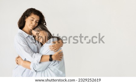 Positive adult woman hugging elderly lady, enjoy love, lifestyle, isolated on white studio background. Family support, female generation, mother daughter relationship, ad and offer Royalty-Free Stock Photo #2329252619