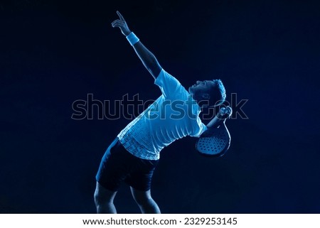 Padel tennis player. Padel open tour. Man athlete with paddle tenis racket on blue background. Sport concept. Download a high quality photo for sports website.