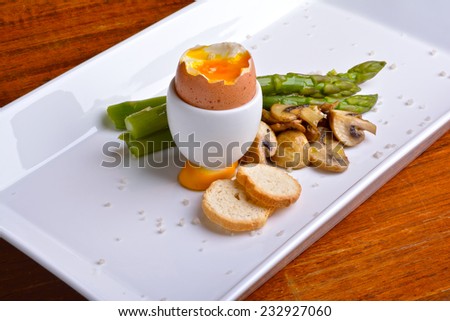 Egg, mushrooms, asparagus, croutons and gray salt