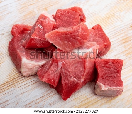 Raw pork neck meat cuts, top view on wooden background fresh slices