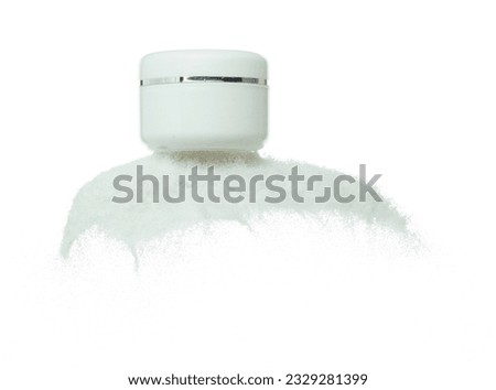 Cosmetic container white bottle fly splashing on white sand. Tube transparent sand powder in mid air. Moisturizer lotion cream bottle explosion flying. White background isolated high speed shutter