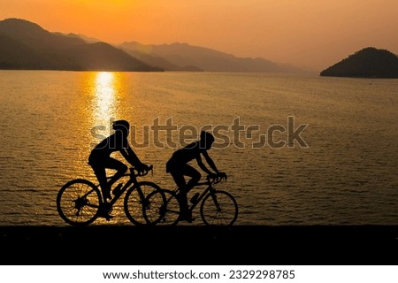 Silhouette of cyclist in motion on the background of beautiful sunset