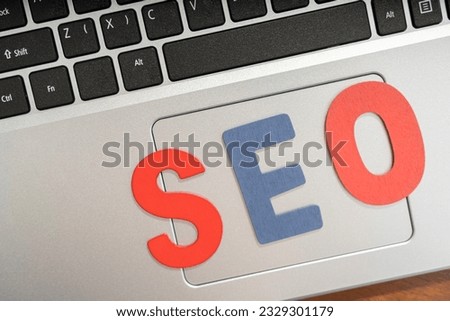 Web analytics and marketing concept. Search engine optimization SEO browsing concept. Laptop with toll and notes on SEO.