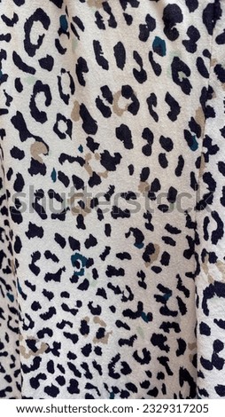 Close-up of texture white fabric cloth textile background. Similar to the texture of leopard skin
