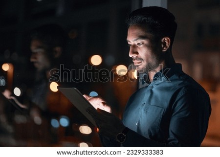 Night, work or man reading on tablet for research, project or planning a proposal in office building, startup or professional employee. Overtime, working or search on internet or online communication