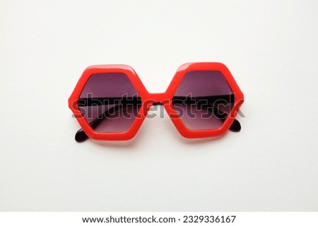 close up red pentagon shape sunglasses isolate on a white  background