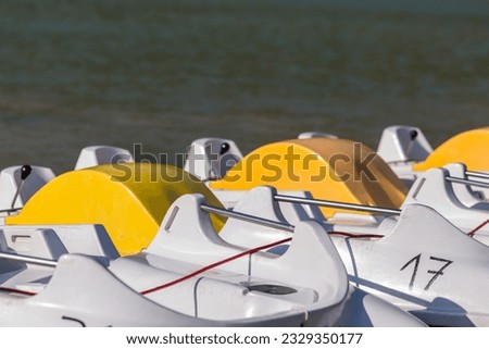 Fragment of catamarans near the lake in daylight.
