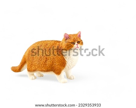 Plastic miniature fat orange white cat isolated on white