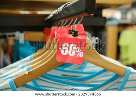 Big sale discount. Tag with a 20% discount on clothes in the store. Close-up selective focus.