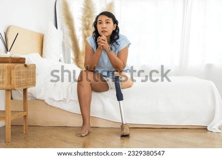 Portrait of disabled asian woman with prosthetic leg sitting at home, feeling hopeful, happy, new life, not discouraged, leg, disability, care, prosthetic equipment, walking doing physical exercise