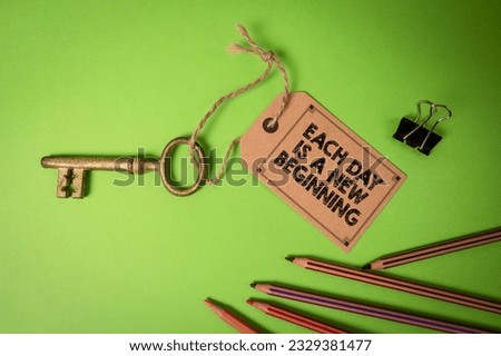 EACH DAY IS A NEW BEGINNING. Cardboard price tag with text on a green background.