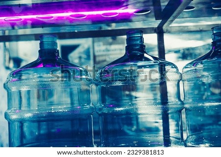 drink water factory using UV light disinfection sterilization system in production line to clean drinking water bottle tank Royalty-Free Stock Photo #2329381813