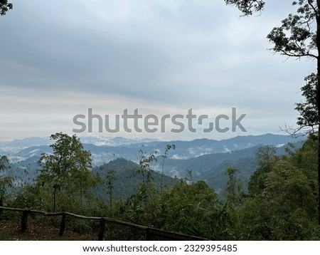 A viewpoint at the top of the mountain overlooking the intricate mountains and dense fog.