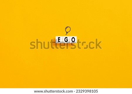 White letter blocks on yellow background with the word ego. Selfishness or inflated ego in psychology concept. Royalty-Free Stock Photo #2329398105