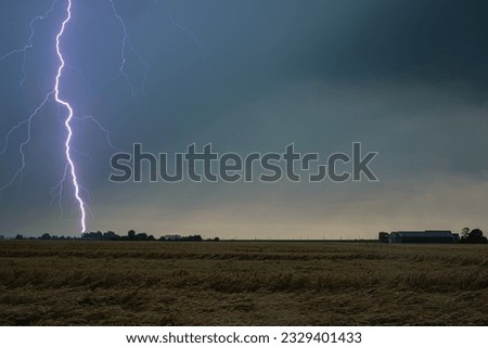 Nearby lightning strikes in a wheat field Royalty-Free Stock Photo #2329401433