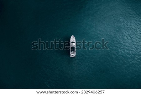 Boat alone in the middle of the ocean, calm water, Drone view - yachting theme.
