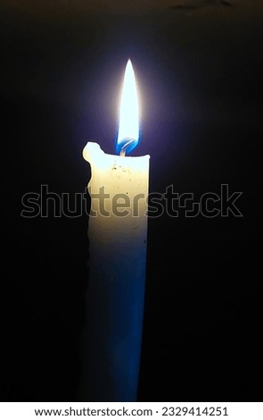 blue flame candle on black background