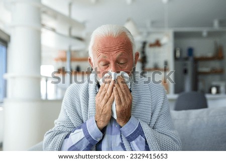 New coronavirus CoVid-19 outbreak situation with pandemic epidemic warning - adult caucasian senior old man with fever symptoms like illness cold seasonal influenza - people and virus concept Royalty-Free Stock Photo #2329415653