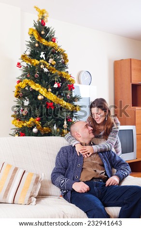 Portrait of Happy couple celebrating Christmas at home