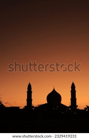 silhouette of the mosque at sunset. A religious structure at sunset, framed by trees and the sky. Royalty-Free Stock Photo #2329419231