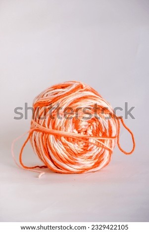 A thread knitting shaped balls on the table with white background