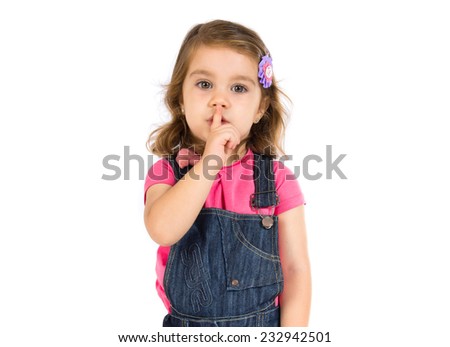 Kid making silence gesture over white background  