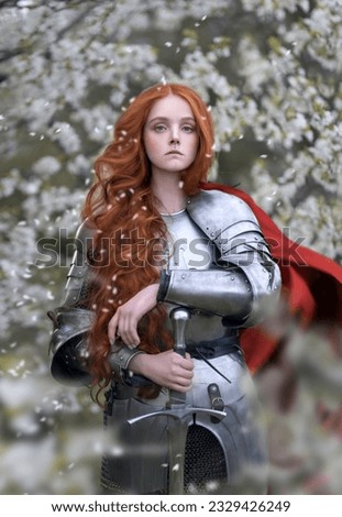 Red-haired warrior in steel armor in a flowering garden Royalty-Free Stock Photo #2329426249