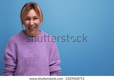 smiling stylish blond young woman in a casual look with a good mood on a bright background with copy space