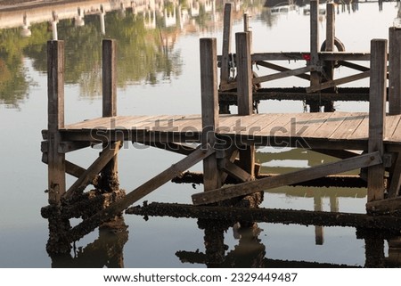 weathered wooden bridge over saltwater marina pier in the Ancol beach jakarta Royalty-Free Stock Photo #2329449487