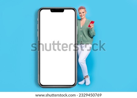 Full length photo of young customer girl pink hair satisfied website digital display hold smartphone isolated on blue color background