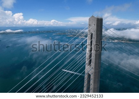 Cable-stayed bridge on a summer day against the background of the city and ships in the sea bay , footage taken from the air on a quadcopter Royalty-Free Stock Photo #2329452133